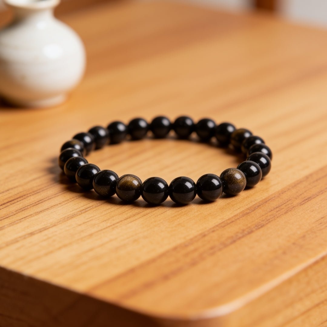 Black obsidian bead detail showing the glassy volcanic surface