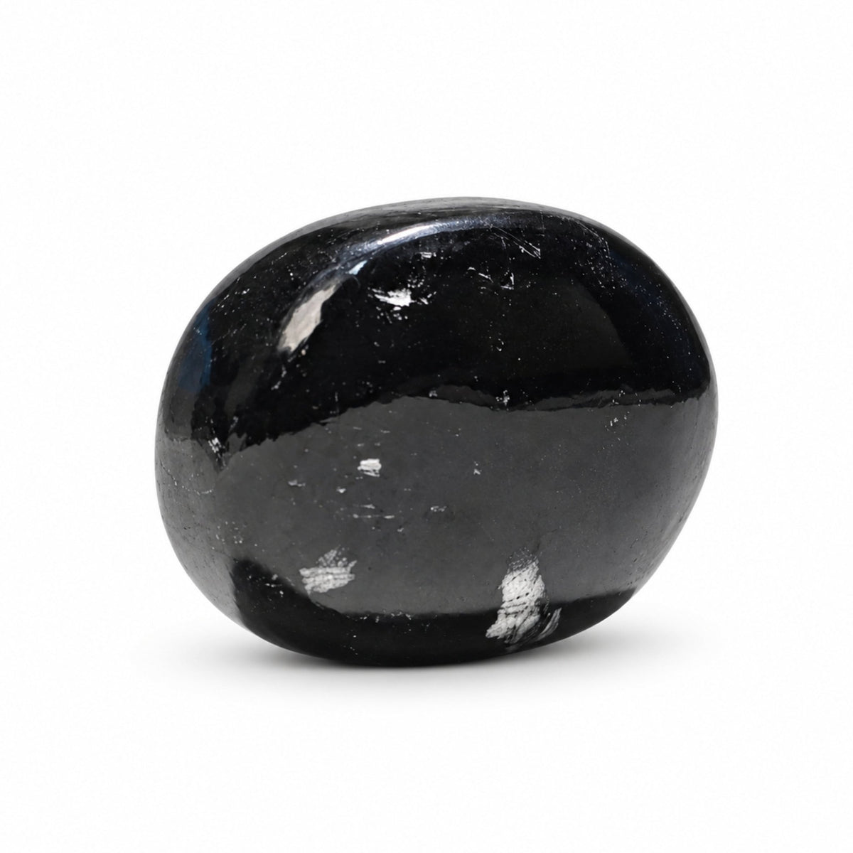 Black Tourmaline stone soap working into a rich, gentle cleansing lather with water under a stream of running water