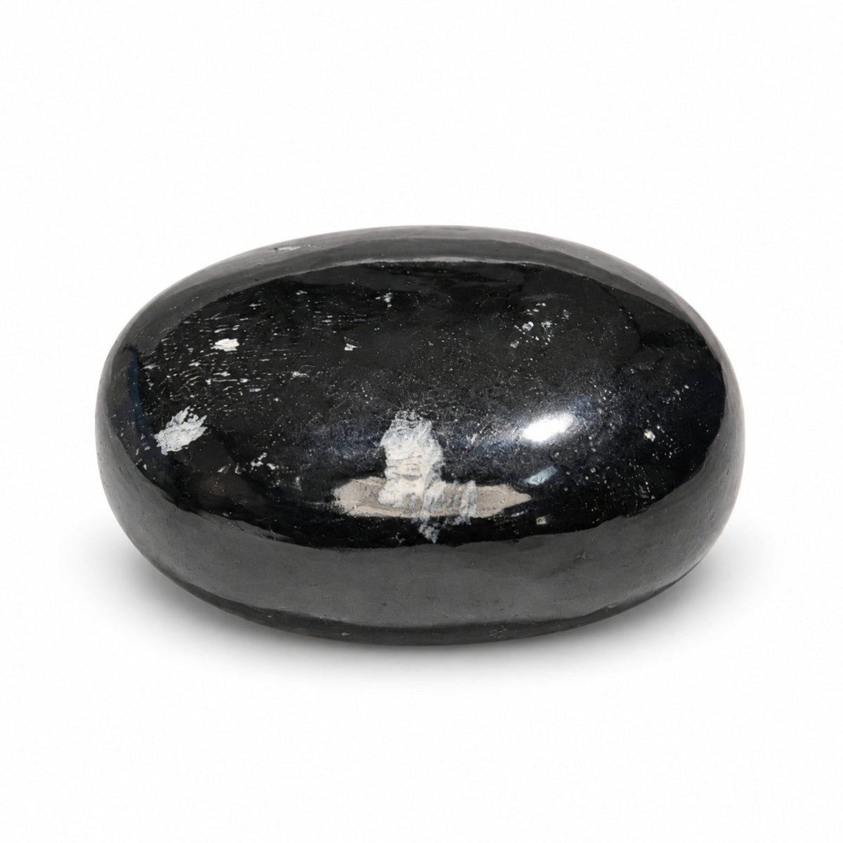 Ergonomic curved Black Tourmaline soap bar resting in open palm demonstrating comfortable grip for bath and shower