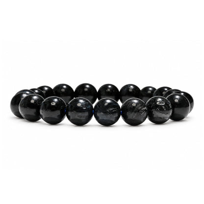 Close-up of 10 mm polished round beads highlighting pronounced silky chatoyancy and shimmering deep navy optical bands