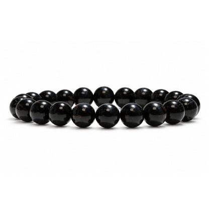 Close-up of 8 mm smooth round beads showing natural silky chatoyancy and shimmering midnight-blue optical bands