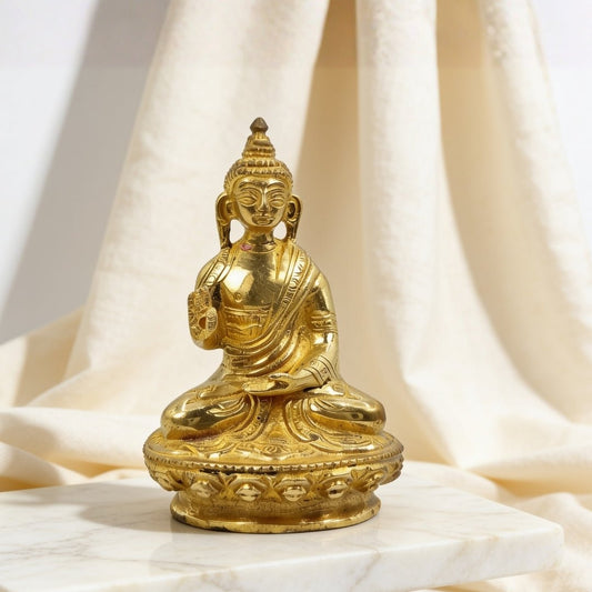 brass Blessing Buddha idol statue on a plain background