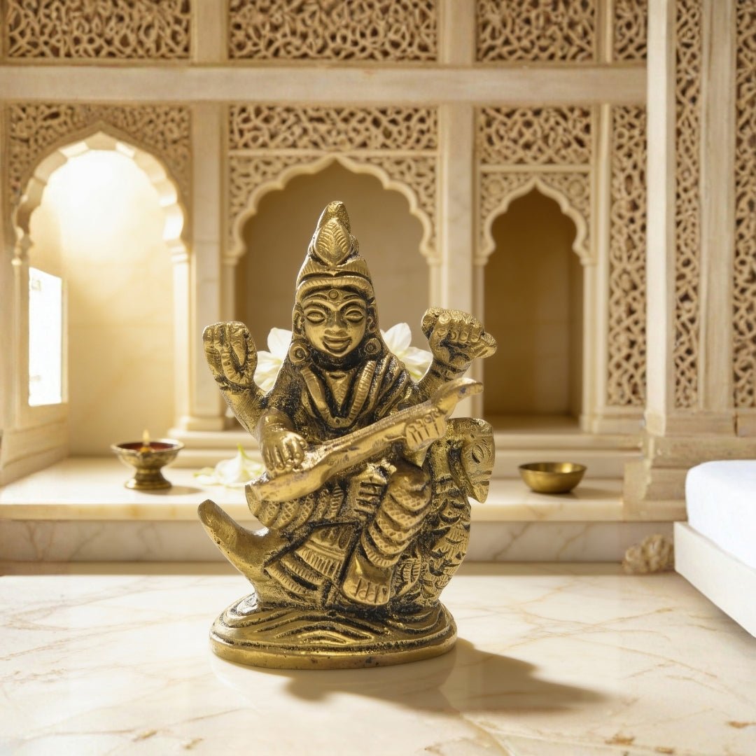 Handcrafted pure brass 2.5 inch Goddess Saraswati idol seated on a blooming lotus pedestal playing the divine veena