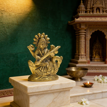 Handcrafted pure brass 3.5 inch Goddess Saraswati murti seated gracefully on a lotus pedestal holding the sacred veena