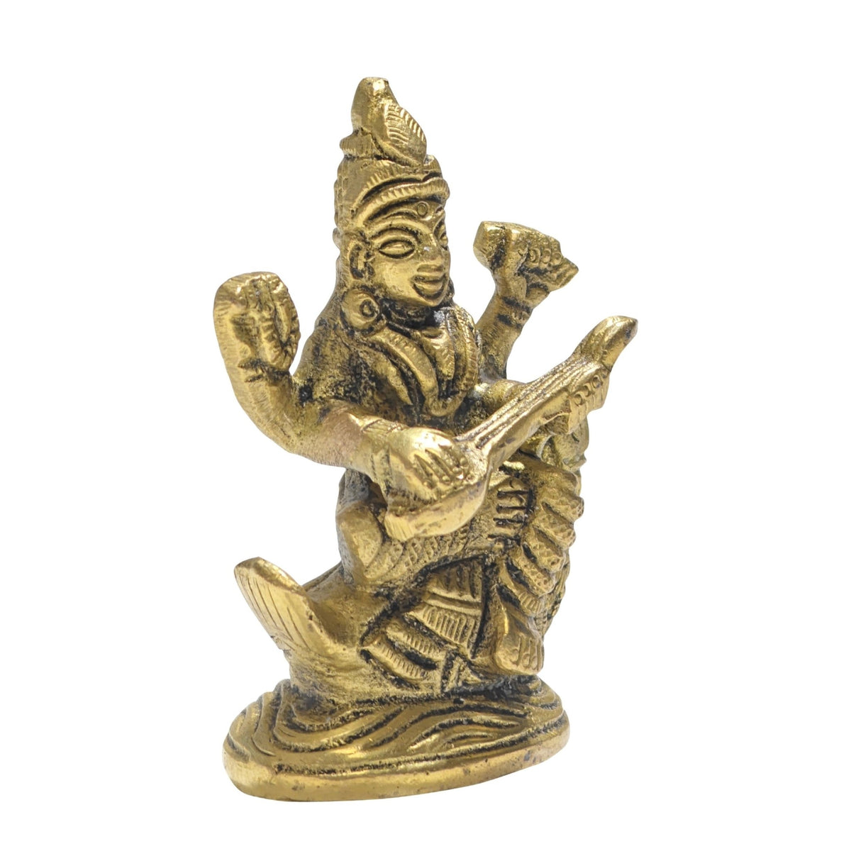 Close-up of intricate brass carving showing detailed facial expressions, crown mukut, veena strings, and holy swan hamsa