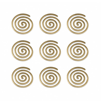 Detailed macro view showing heavy cast brass metal surface, rich golden polish, rounded spiral contours, and smooth edges