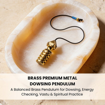 brass premium dowsing pendulum resting in the palm for scale