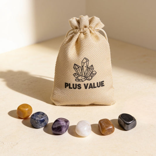 seven chakra tumble stones arranged around a Plus Value drawstring pouch