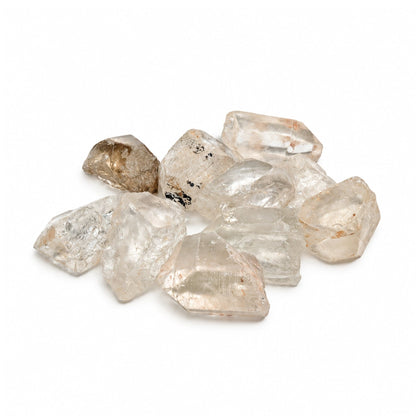 Close-up of unrefined Clear Quartz rough stone showing vitreous luster, translucent icy clarity, and natural crystalline striations