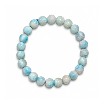 Close-up of 7 mm polished beads highlighting authentic sky-blue hues, cloudy white swirls, and vitreous silky luster