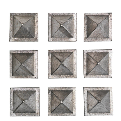 Detailed macro view showing authentic cast lead metal surface, natural matte grey sheen, and beveled pyramid facets