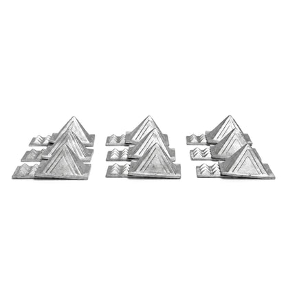 2.5-inch heavy lead pyramid resting in hand demonstrating substantial weight, dense metal feel, and tabletop scale