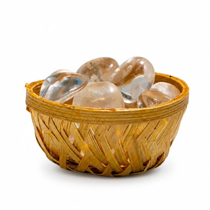 Close-up of polished natural Clear Quartz pebbles showing icy translucent clarity, internal veil inclusions, and glassy shine
