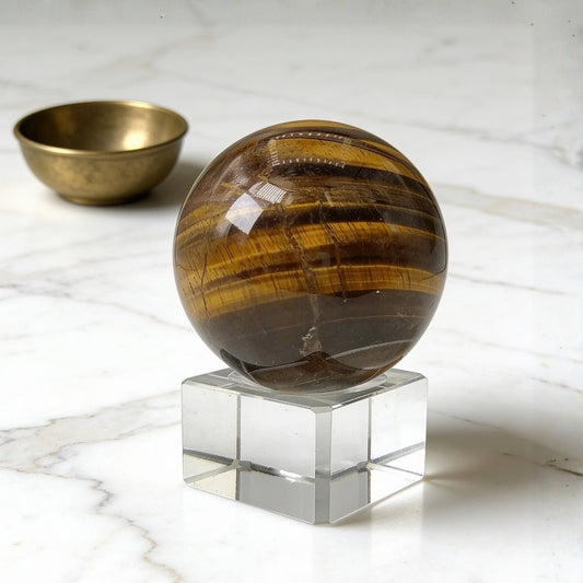 Tiger eye stone sphere, polished natural tiger eye ball showing the golden chatoyant bands
