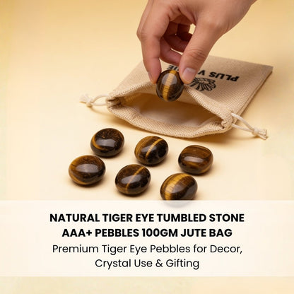 natural tiger eye tumbled pebble held in hand for size reference
