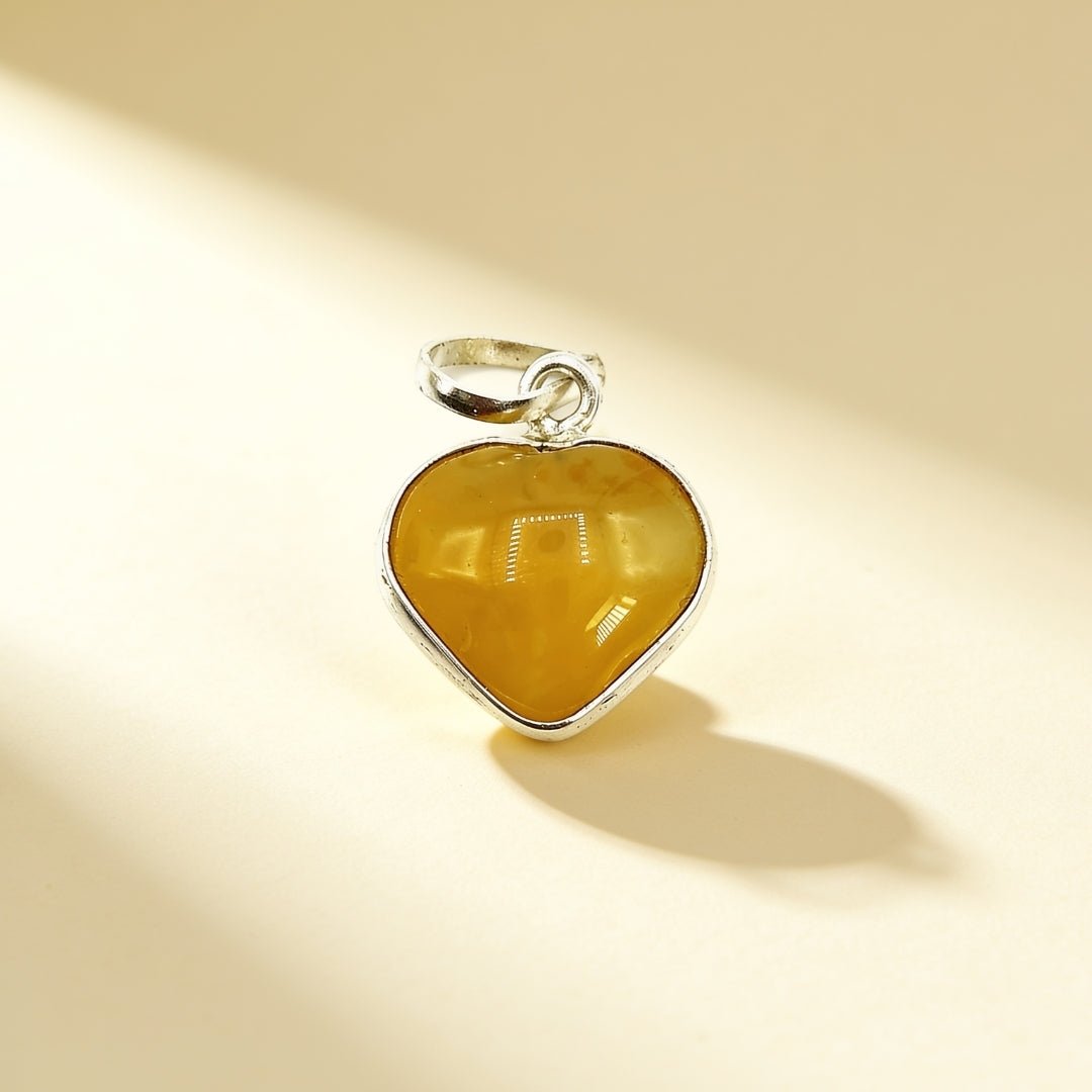 Natural Yellow Aventurine carved heart pendant with polished metal bail and black cord