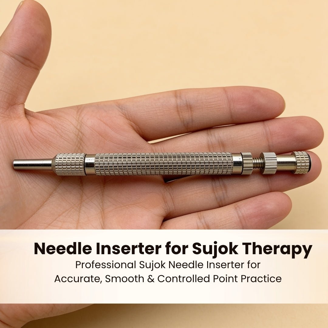 Sujok needle inserter positioned over palm acupressure point demonstrating single-click micro needle application
