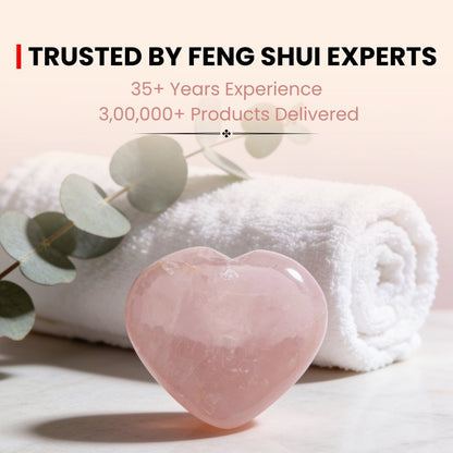 polished rose quartz heart used as a handheld massage or meditation stone