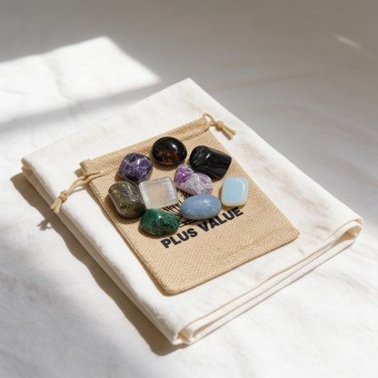 Natural polished Purple Fluorite tumbled stones 100gm spilling out of an eco-friendly drawstring jute pouch for mental focus and Reiki healing