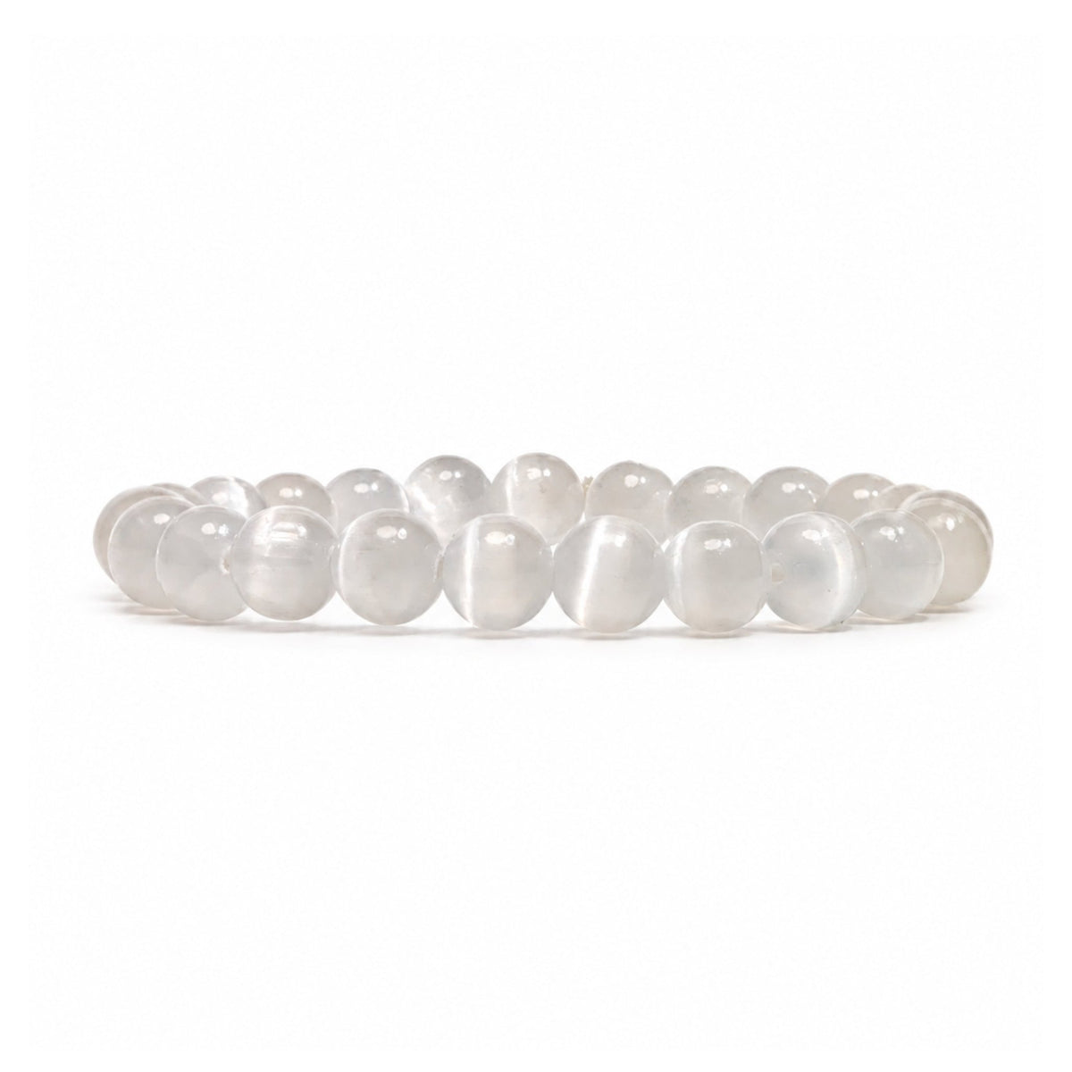 Close-up of 8 mm polished beads displaying authentic milky white translucence, fibrous crystal striations, and luminous cat-eye sheen