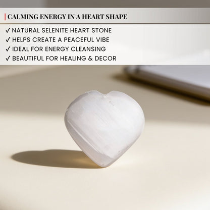 polished selenite heart stone held in hand for size reference