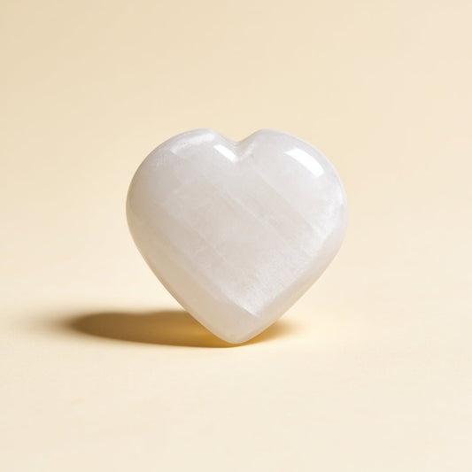 polished selenite heart stone with a soft white mineral finish