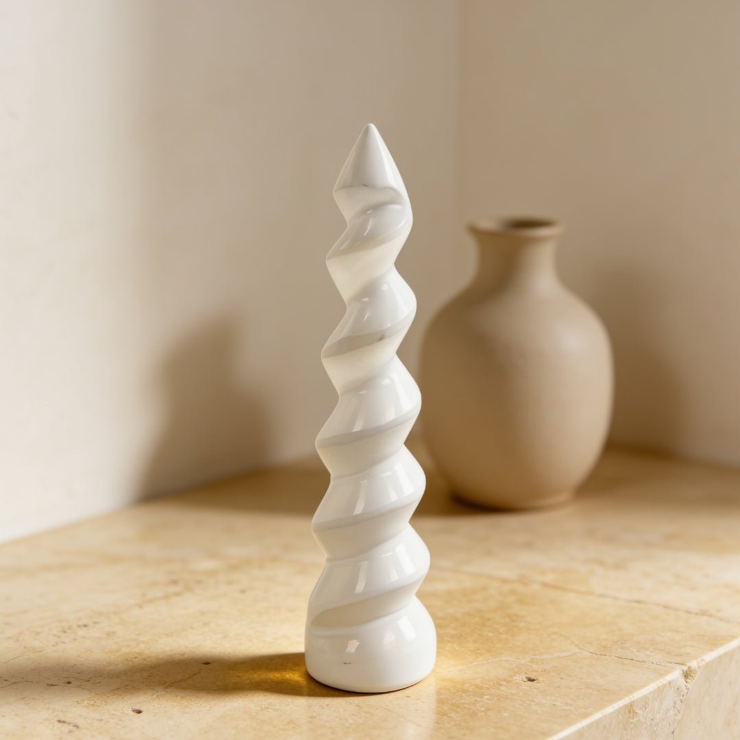 selenite unicorn horn spiral wand 6 inch on a plain background
