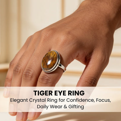 tiger eye crystal ring worn on a finger for scale