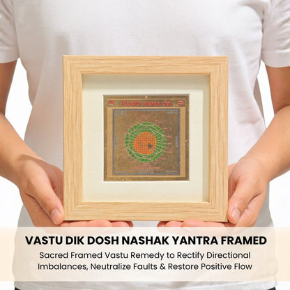 Vastu Dik Dosh Nashak Yantra positioned on a wall above the main entrance and in a home temple beside a brass diya and flowers