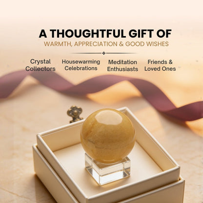 Yellow Aventurine crystal sphere styled on an altar beside incense and candles for focused meditation