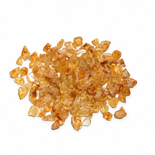 Natural polished Yellow Citrine crystal chips and irregular crushed quartz nuggets arranged in a decorative glass bowl