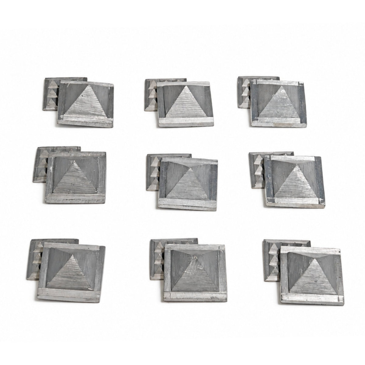 Set of 9 solid Zinc 1 inch Vastu pyramids arranged in a 3x3 geometric grid for North-East Ishanya zone dosha rectification
