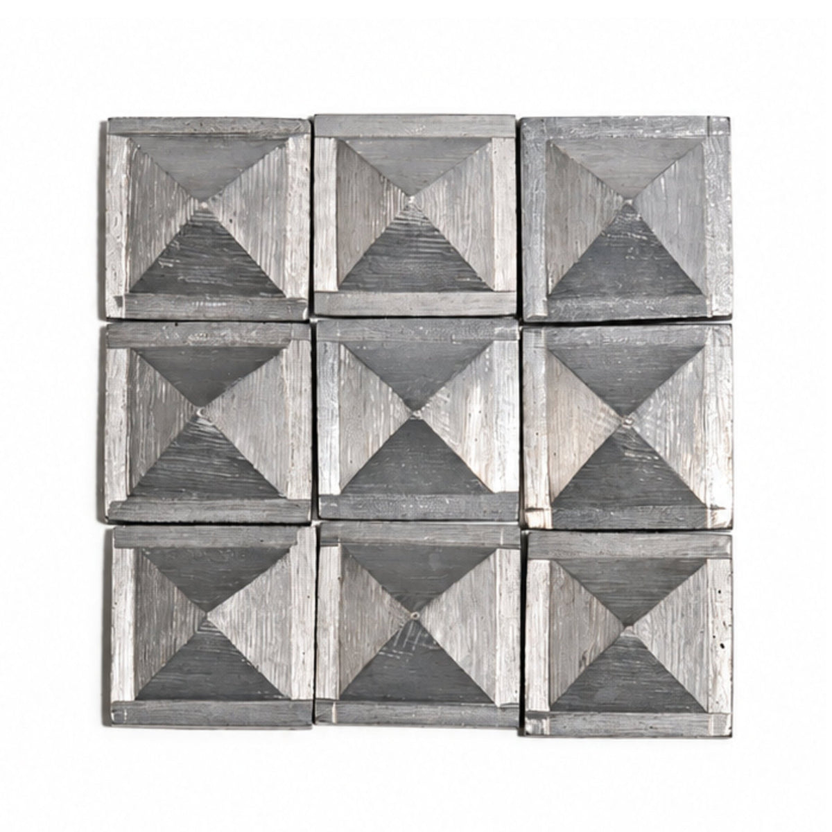 Set of 1-inch solid zinc pyramids resting in open hand demonstrating compact size, substantial metallic weight, and smooth finish