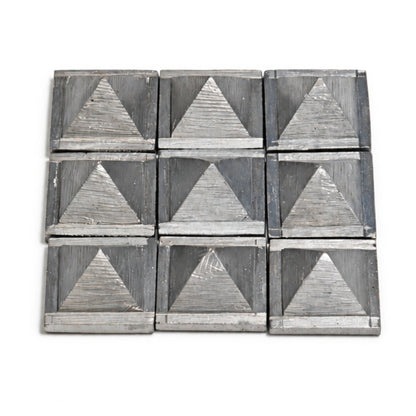 Nine zinc pyramids positioned discreetly along the North-East floor boundary near a puja altar to balance water element vibrations
